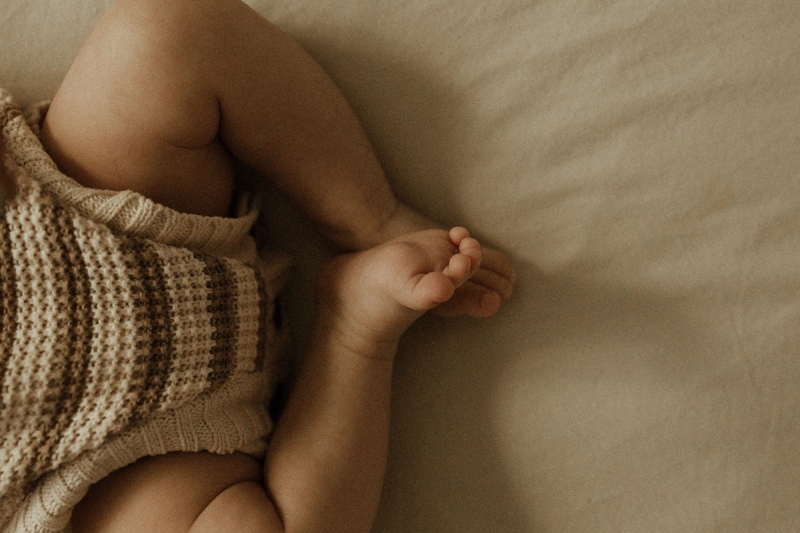 Baby toes illuminated by window light captured by Denver Newborn Photographer